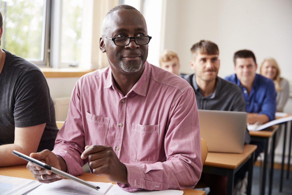 man sitting at his computer looking up to his left